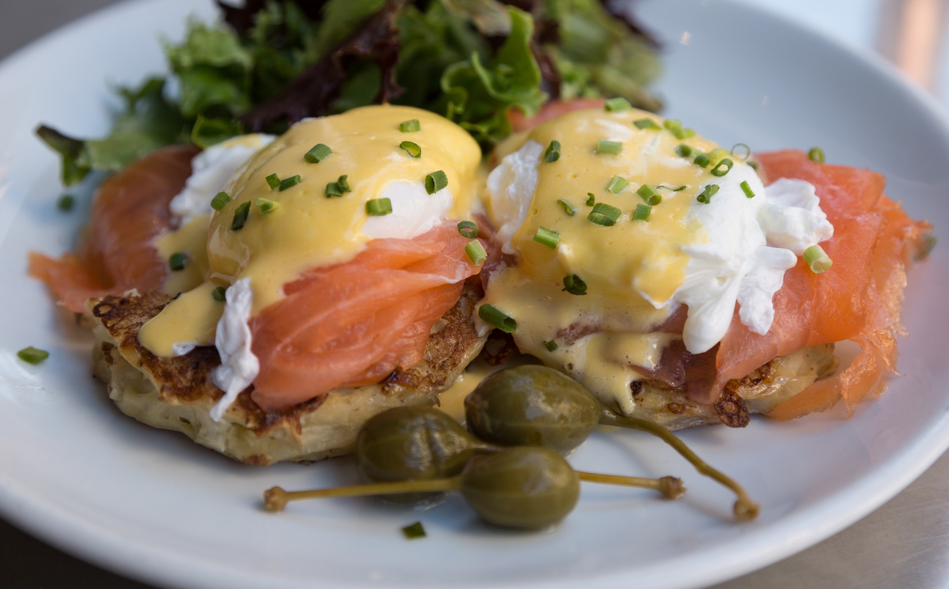 salmon benedict with olives and salad